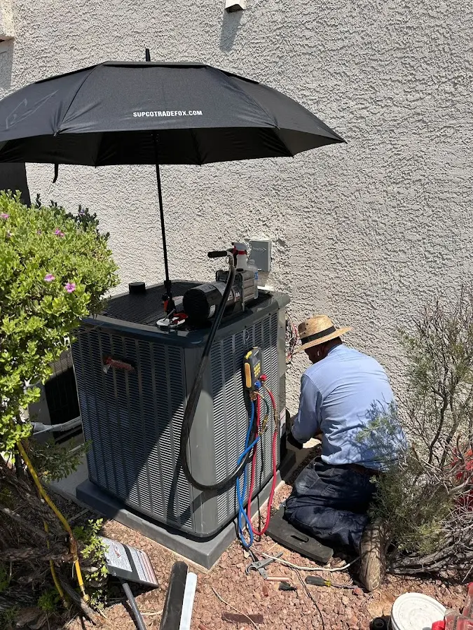 HVAC technician performing outdoor AC maintenance in Waupun